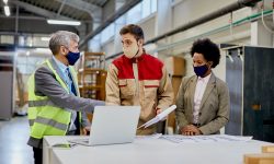 Woodworking company managers communicating with male worker at production facility. Woodworking company managers communicating with male worker at production facility.